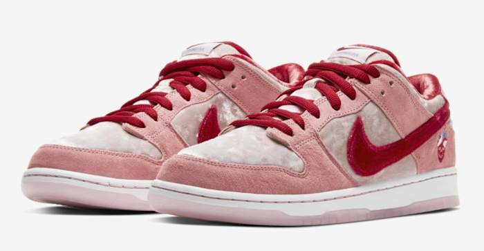 View of pink and red Nike Dunk shoes.